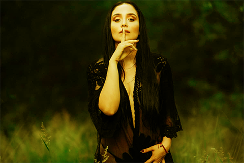 mujer que se tapa la boca con un dedo